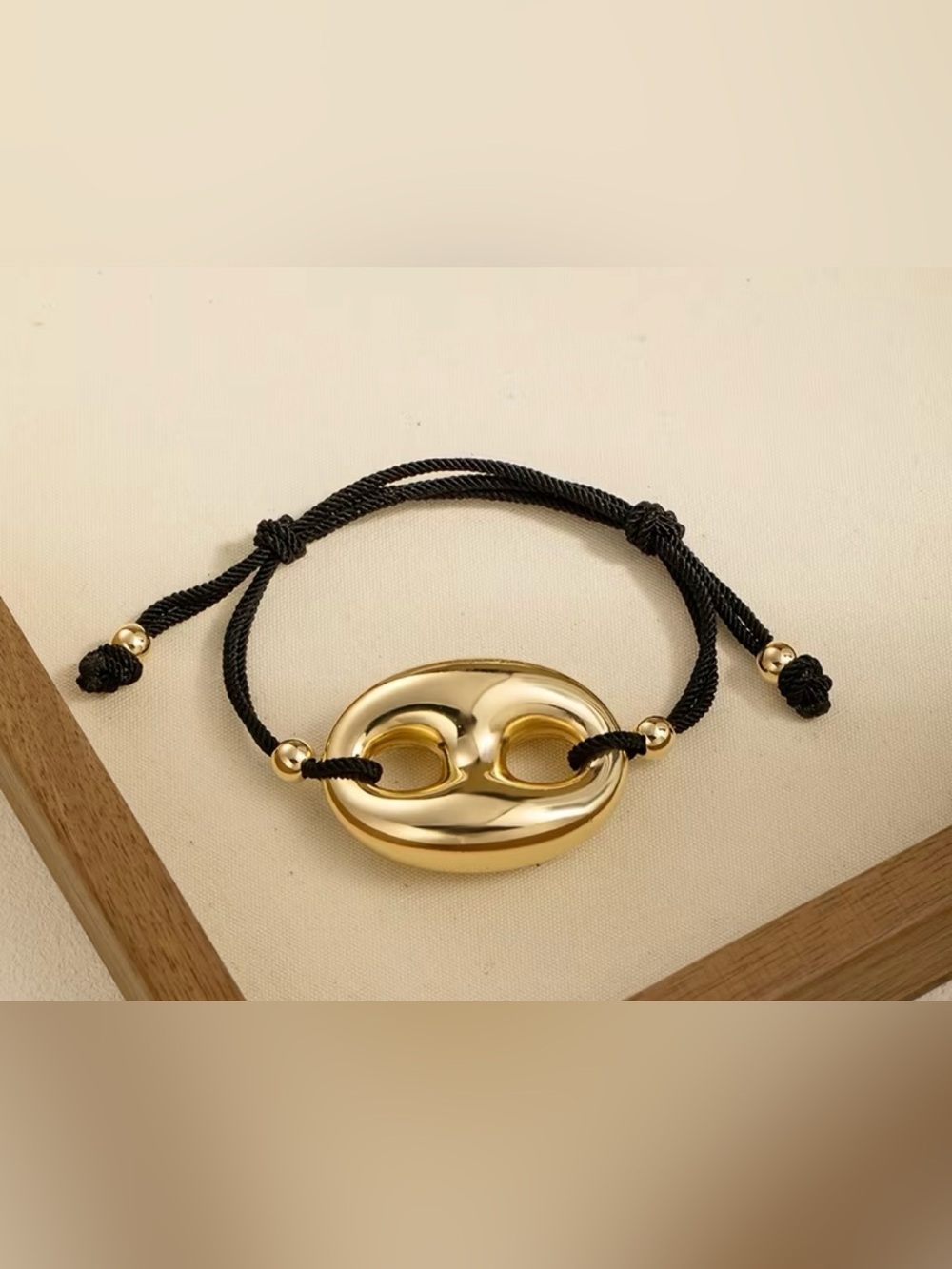Gold Oval Knot Bracelet with Black Cord